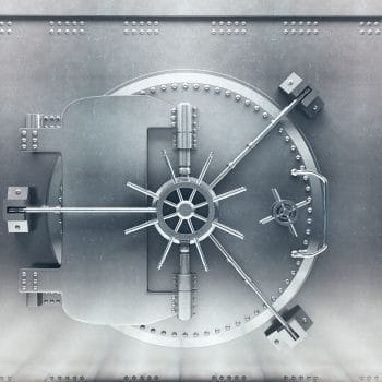 Front view of light silver bank vault door, closed